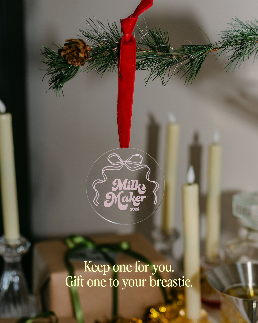 2026 Milk Maker Christmas ornament hanging from a pine garland with red velvet ribbon, keepsake gift for breastfeeding moms by The Little Milk Bar