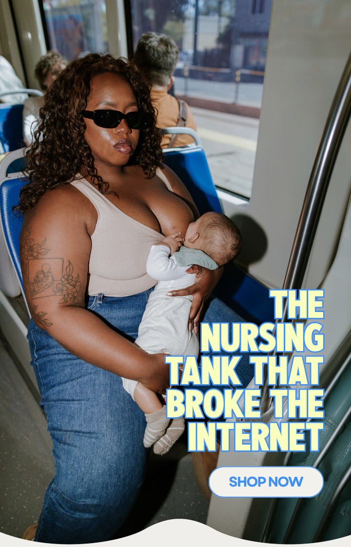 Mom breastfeeding her baby on a train wearing The Little Milk Bar nursing tank